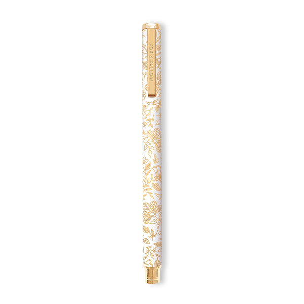 Gold pen with floral design on a white background