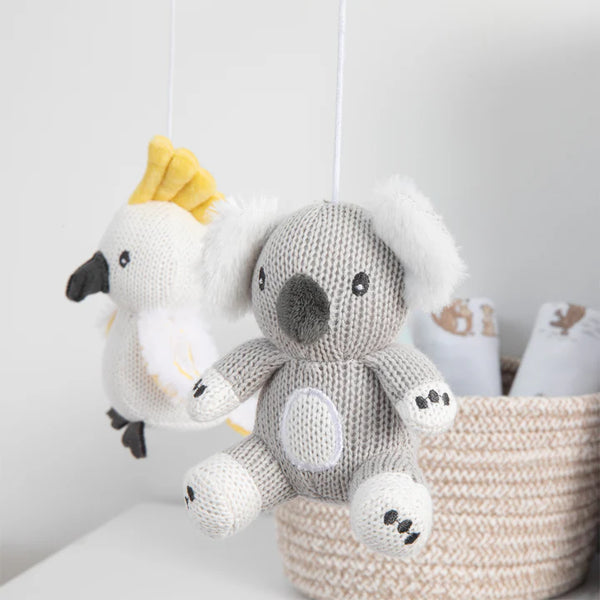 Knitted koala and bird toys hanging from a string against a white background