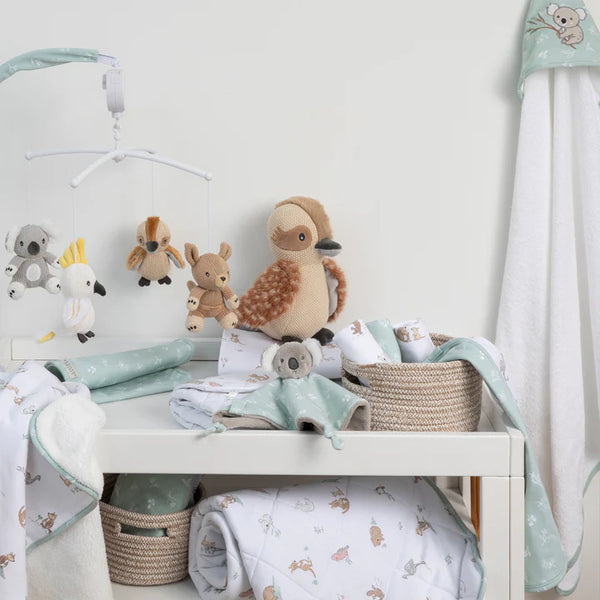 Baby nursery with crib, toys, and bedding in a room setting.