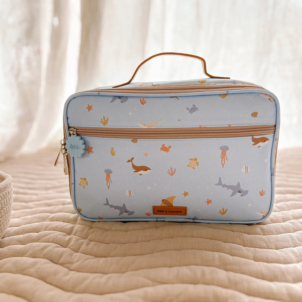 Rectangular blue pouch with animal pattern on a beige surface