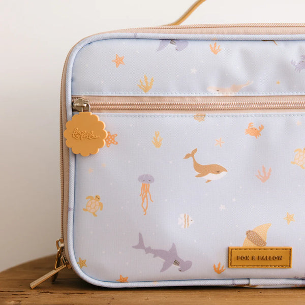 Portable lunch bag with ocean-themed design featuring animals on a light background