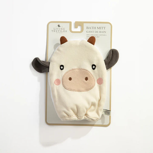 Cow-shaped bath mitt on a packaging card with 'Living Textiles' branding.