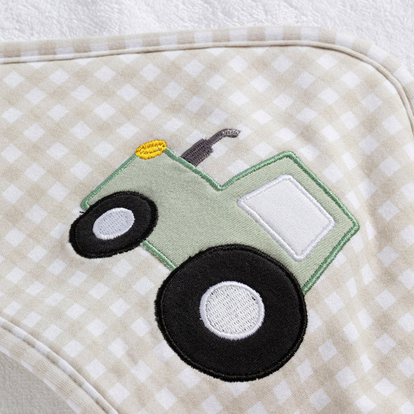 Green tractor applique on a beige and white checkered fabric