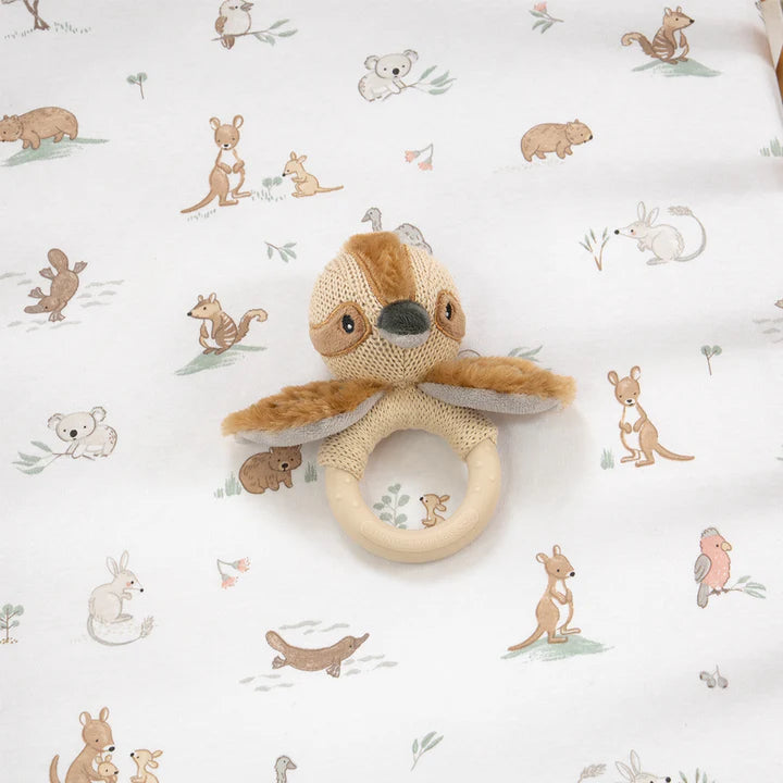 Knitted toy with a ring on a white background with animal patterns