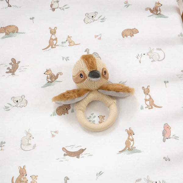 Knitted toy with a ring on a white background with animal patterns