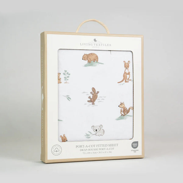 Packaged port-a-cot fitted sheet with animal illustrations on a light gray background