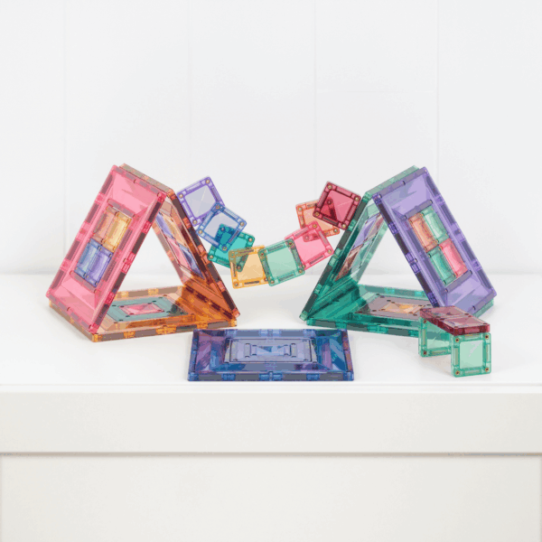 Colorful transparent geometric building blocks on a white surface