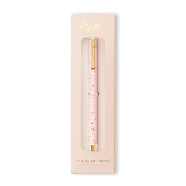 Pink roller pen with gold accents in packaging on a white background