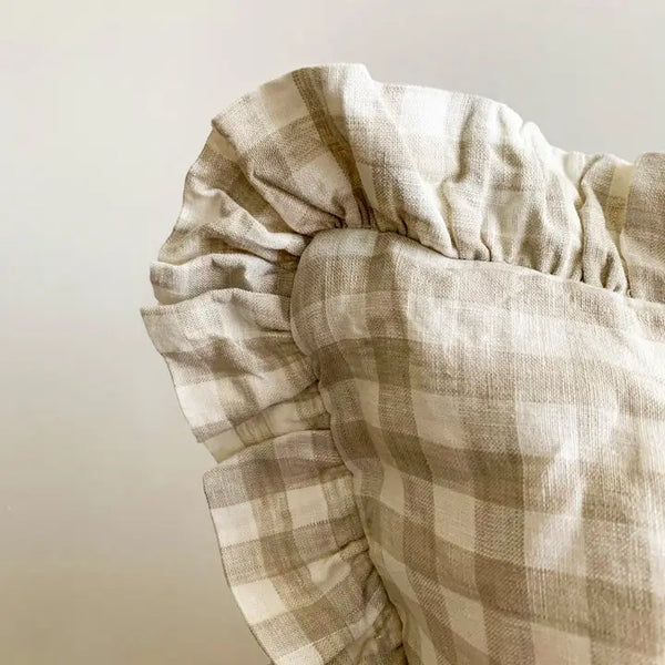 Close-up of a checkered fabric with a neutral color palette on a plain background