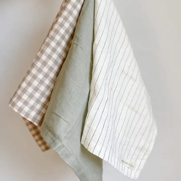 Two fabric samples, one checkered and one with a stripe pattern, on a neutral background.