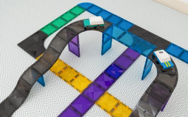 Colorful toy train track set on a textured surface