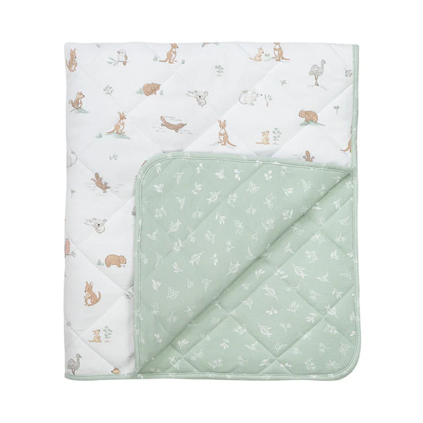 Quilted baby blanket with animal pattern on one side and solid color on the other, on a white background.