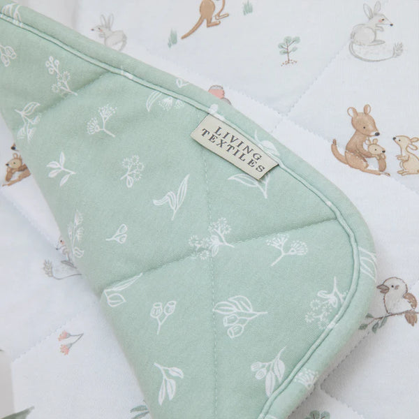 Green textured fabric with a label on a patterned background