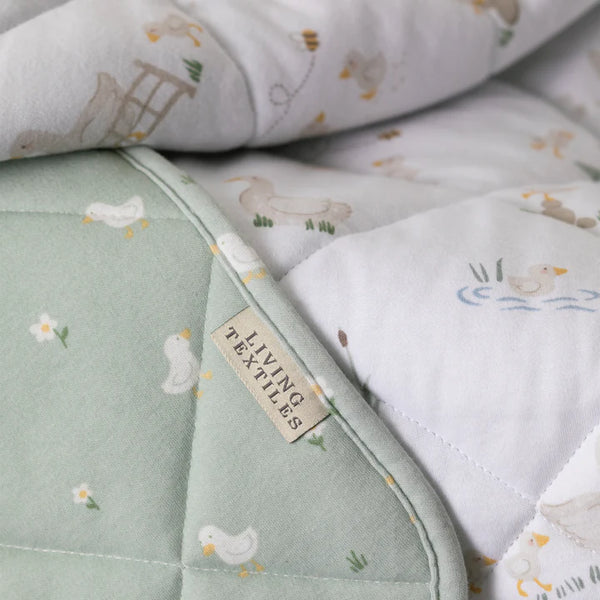Textured fabric with animal pattern and 'Living Textiles' label