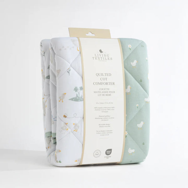 Quilted cot comforter with packaging on a white background