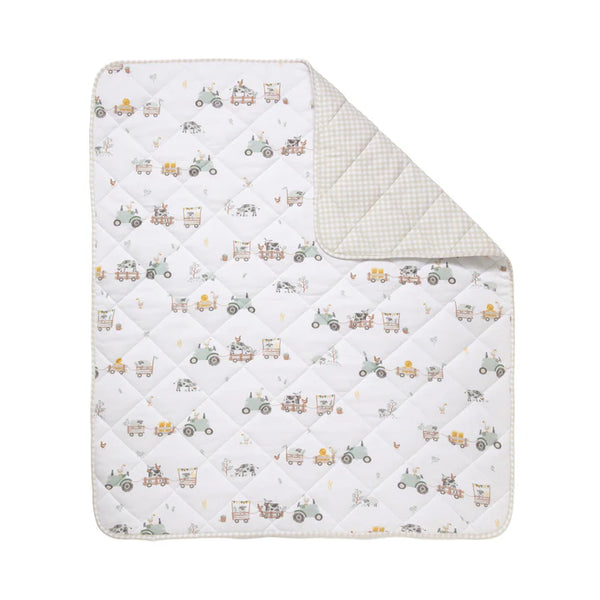 Quilt with tractor pattern on a white background