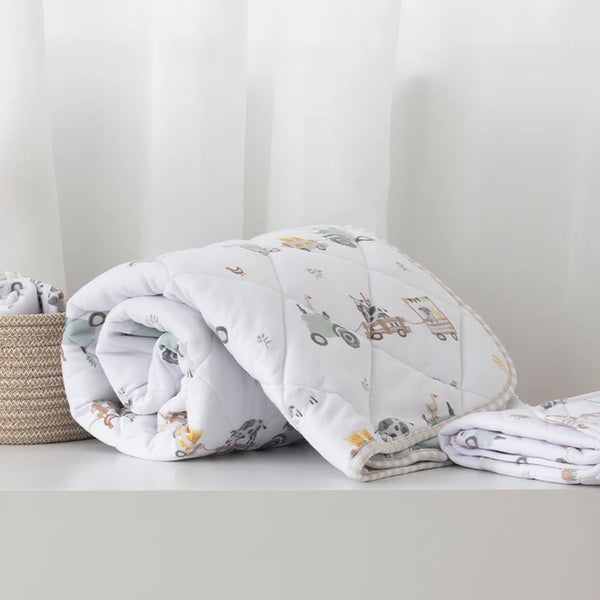 Folded baby blanket with animal pattern on a white surface