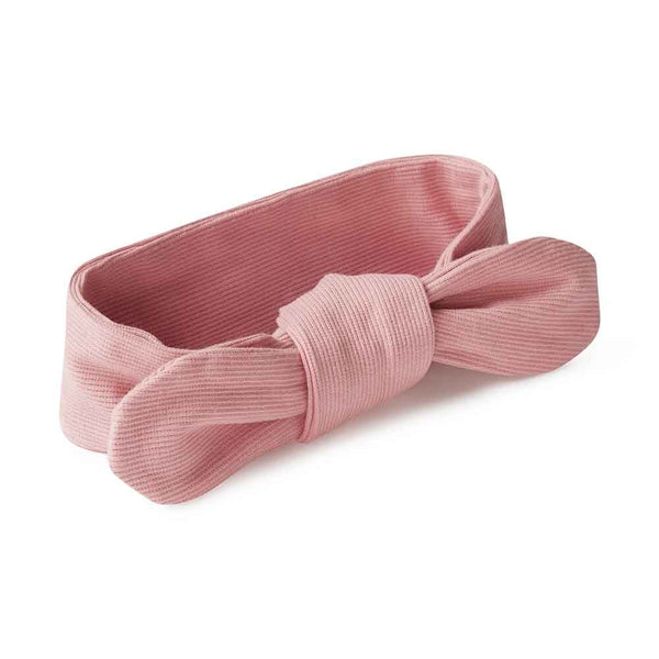 Pink headband with a bow on a white background