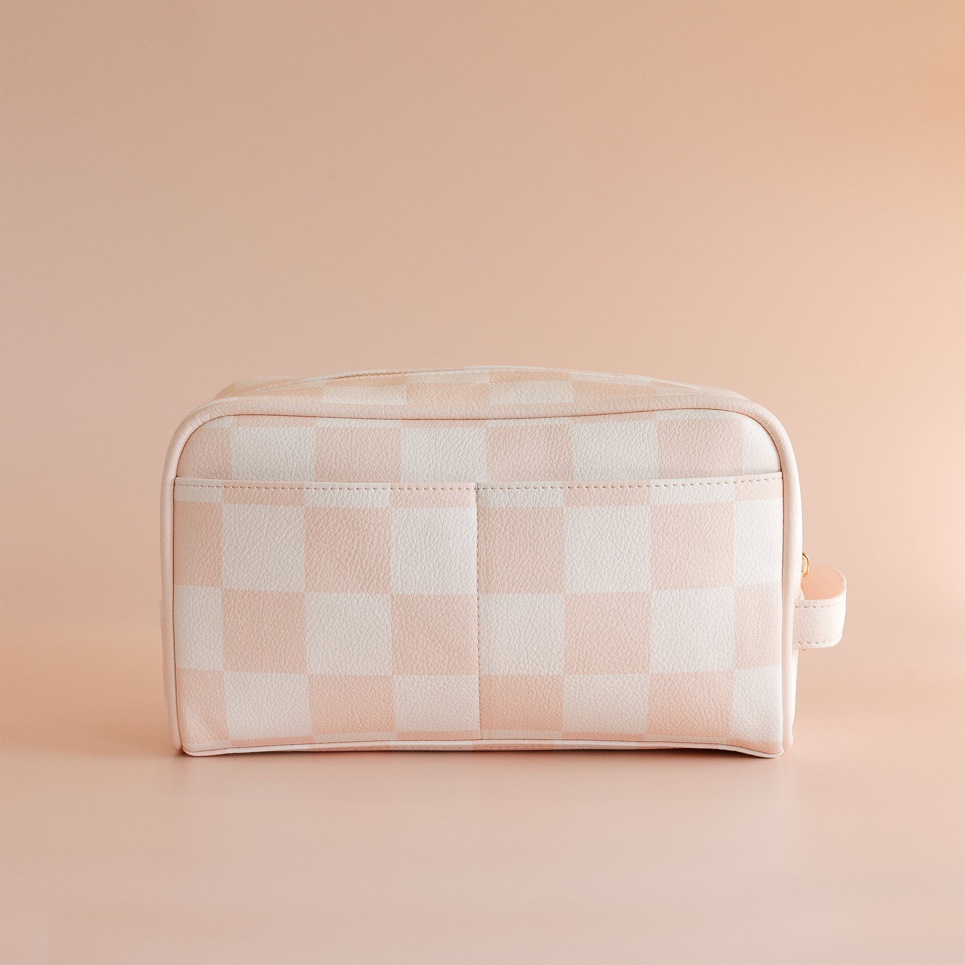 Checkered toiletry bag on a beige background