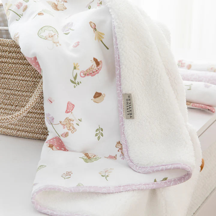 Floral patterned baby blanket with soft texture on a white background