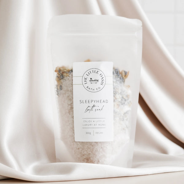 Sleepyhead bath salt package on a satin background