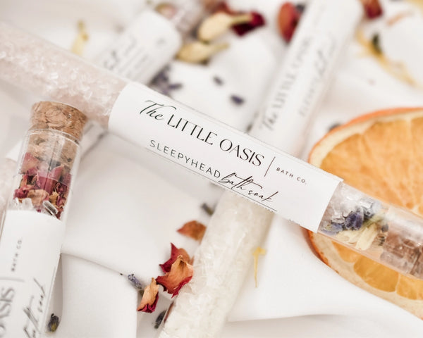 Bath soak packaging with 'The Little Oasis' label on a white background