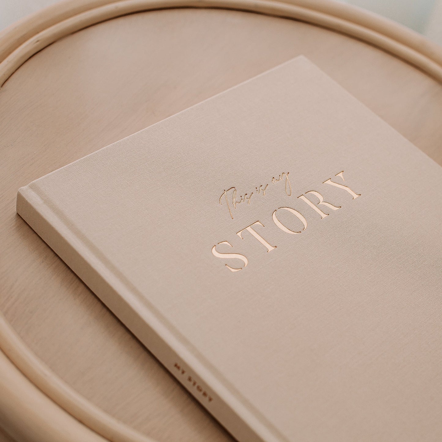 Beige book titled 'Your Story' on a matching beige surface