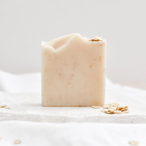 Bar of soap with oatmeal pieces on a white background