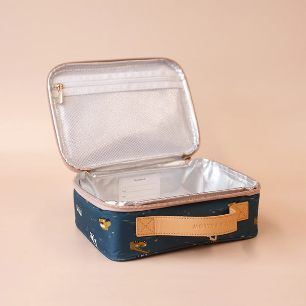 Insulated lunch bag with a gold zipper on a beige background