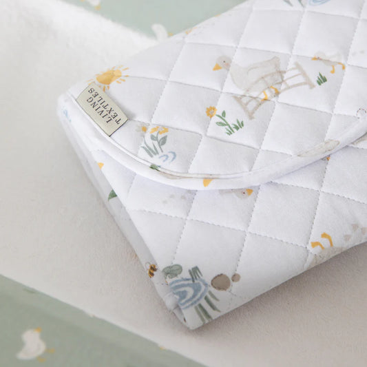 Quilted baby blanket with animal patterns on a light background