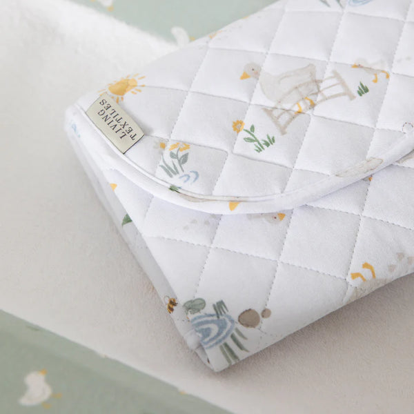 Quilted baby blanket with animal patterns on a light background