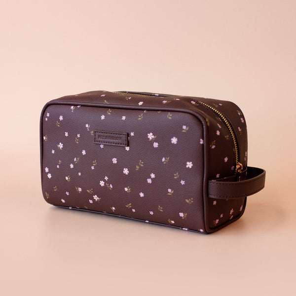 Floral-patterned toiletry bag on a beige background