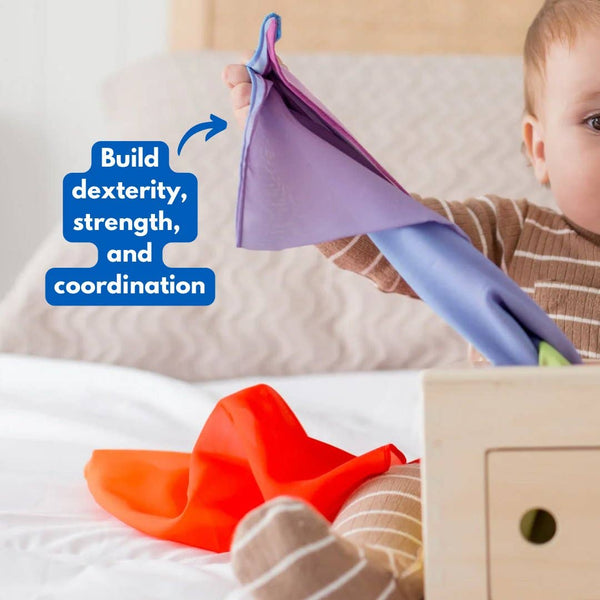 Child playing with colorful toys on a bed, promoting dexterity, strength, and coordination.
